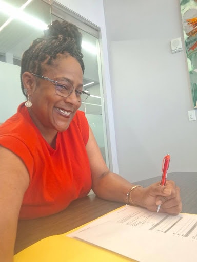 Rosalind Ross signing her homeownership paperwork at Dallas Area Habitat for Humanity